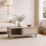image of taupe coffee table with right hand rattan drawer with gold handle, in living room scene