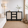 image of black rattan sideboard with small gold handles next to tall floor lamp in living room