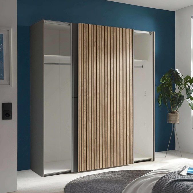 image of wide wardrobe with two sliding doors overlapping in the middle to reveal two sides of storage space