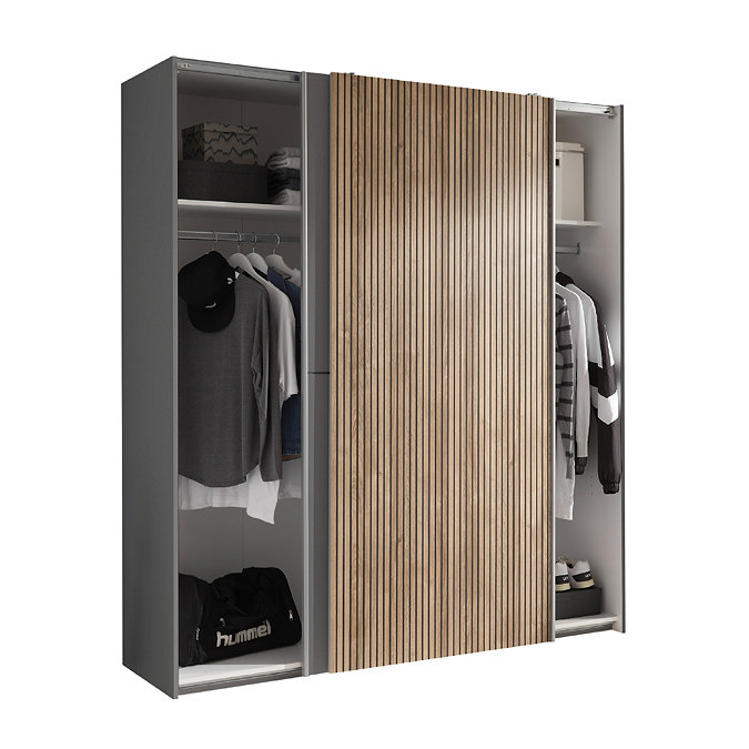 image cut out on white background of wide wardrobe with sliding doors pulled to overlap in the middle, showing two sides filled with clothes