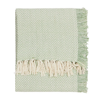 image cut out on white background of leaf green patterned throw with natural tasseled edges folded up