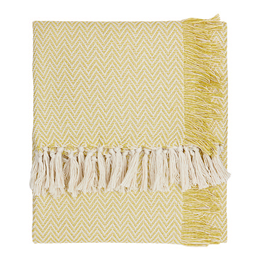 close up image of yellow patterned throw with tasseled edges
