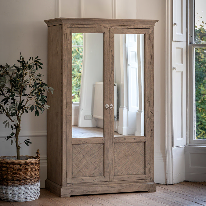 image of rustic wardrobe with two mirrored doors against cream wall