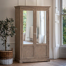 image of rustic wardrobe with two mirrored doors against cream wall