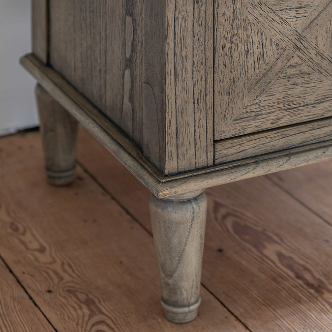 close up image of elegant wood feet of bedside table
