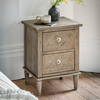 image of rustic, lightly patterned ashy wood bedside table with two drawers, on wooden flooring topped with mug and vase
