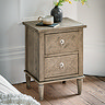 image of rustic, lightly patterned ashy wood bedside table with two drawers, on wooden flooring topped with mug and vase