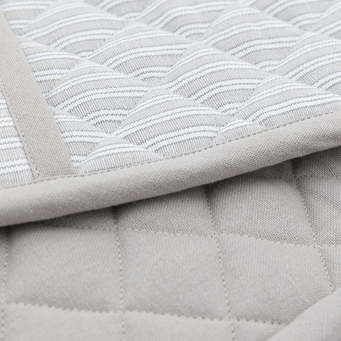 close up image of soft grey stripe oven glove, highlighting quilted texture