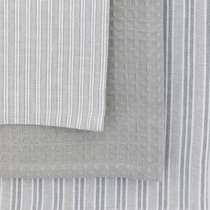 close up swatch image of three slightly different grey tea towel patterns, variations of subtle grey stripes