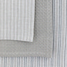 close up swatch image of three slightly different grey tea towel patterns, variations of subtle grey stripes