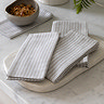 image of woven stripe soft grey napkins piled on white marble countertop