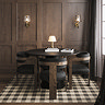 image of round black dining table with velvet chairs tucked round it