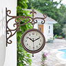 image of wall clock on white villa wall with pool in background
