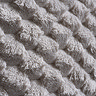 close up image of off-white faux fur texture of headboard