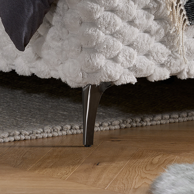 close up image on sleek black metal legs of slatted bed